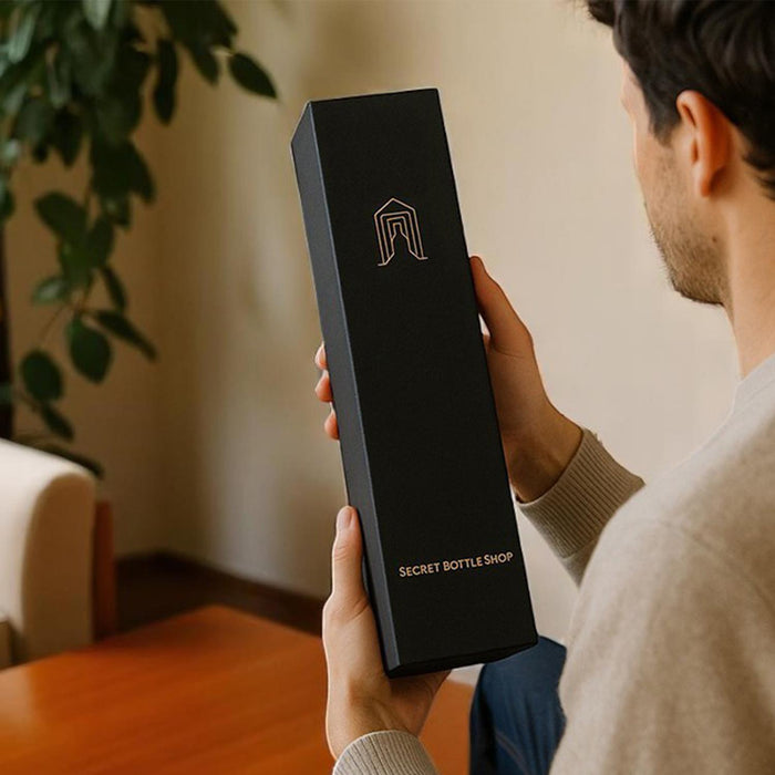 Person holding a Secret Bottle Shop wine gift box
