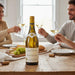 Friends enjoying a meal with a bottle of Joseph Drouhin Macon Villages