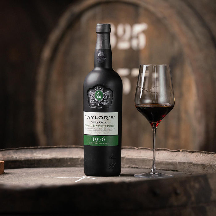 Taylor's Very Old Single Harvest Port with a poured glass in a wine cellar
