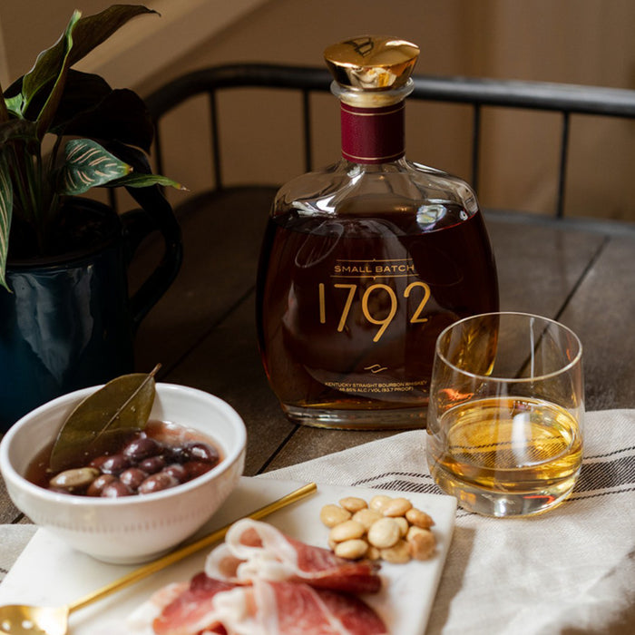 bottle of 1792 small batch Kentucky straight bourbon and olives with charcuterie