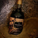 Bottle of The Kraken Black Spiced Rum on a beach