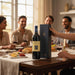 People sitting around a table with wine glasses and a bottle of Chateau Smith Haut Lafitte Pessac-Leognan & Secret Bottle Shop wine gift box