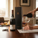 Person pouring Paul Jaboulet Aine Hermitage La Chapelle 1982 into a glass with Secret Bottle Shop gift box to the side