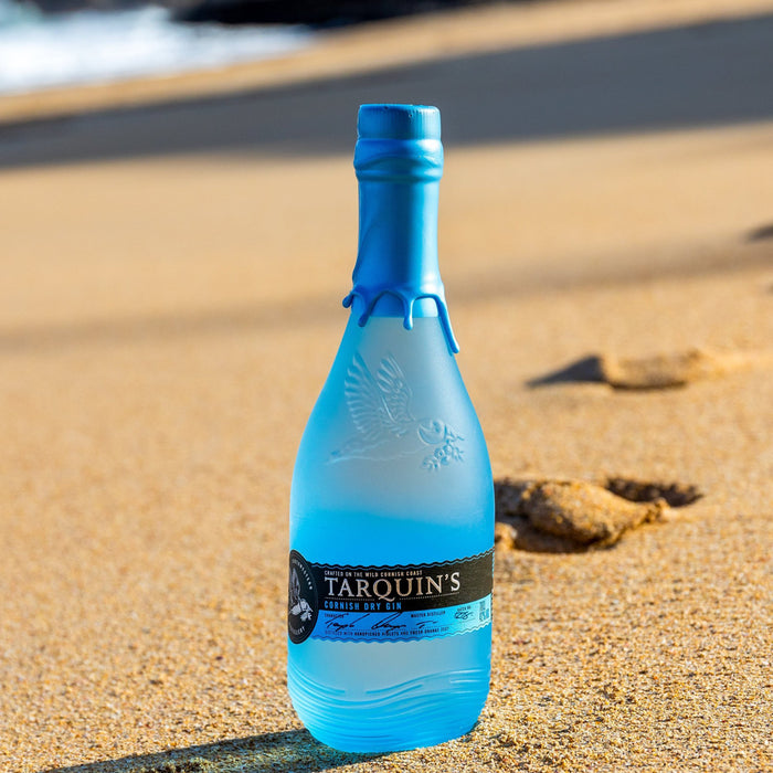 Bottle of Tarquin's gin on a sandy beach