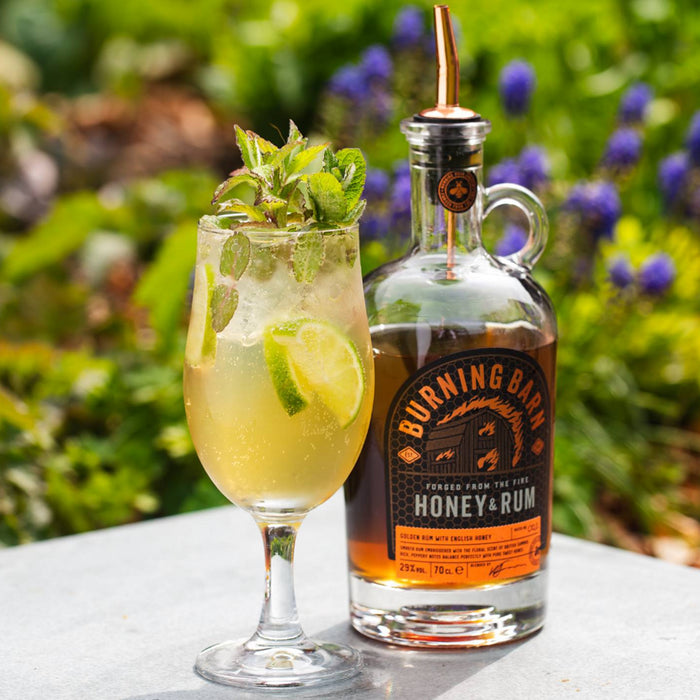 Bottle of Burning Barn Honey & Rum with a cocktail