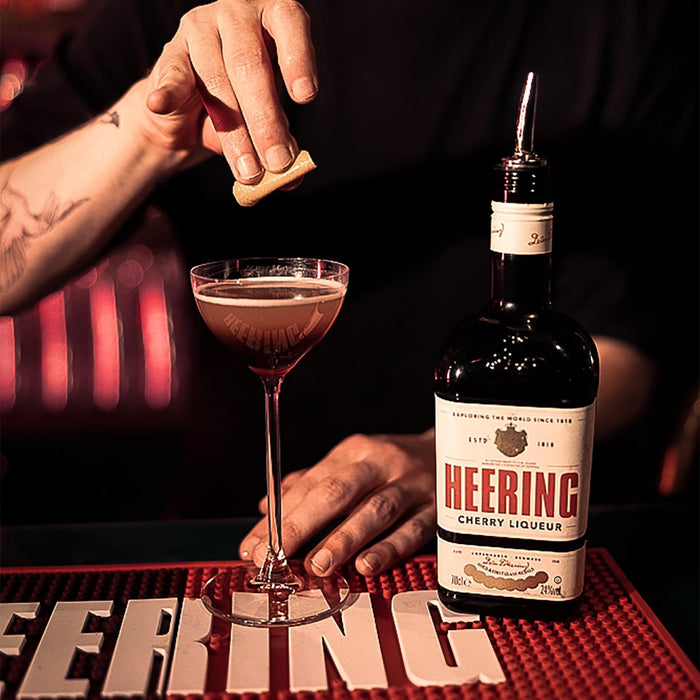 Bartender Making Cherry Heering Liqueur Cocktail