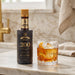 Angostura 200 bottle with a cocktail on a marble countertop