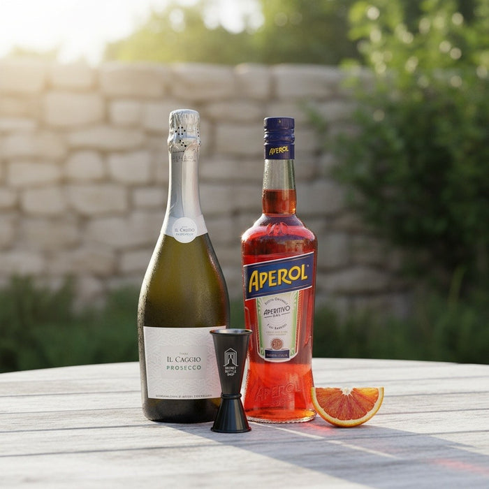 Two bottles on a table with a stone wall and greenery in the background