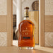 Bottle of Appleton Estate 15-year-old rum on a wooden surface with decorative background