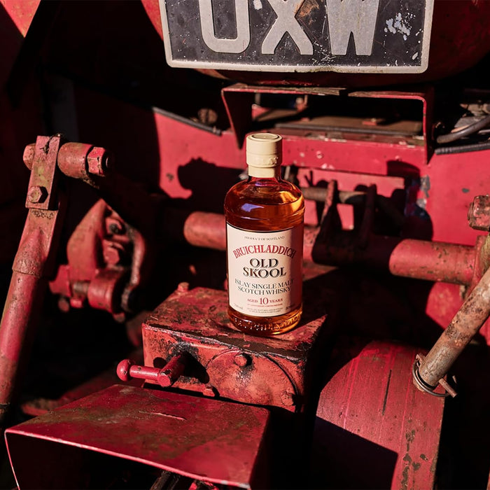 Brichladdich Old Single Malt whisky bottle on a vintage red tractor