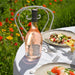 Bottle of Rosé wine on a table with a plate of salad in a garden setting
