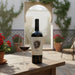 Wine bottle and glass on a table with a decorative background