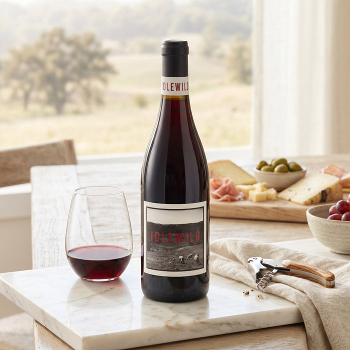 Idlewild Lost Hills Ranch Dolcetto in a home setting with cheese, tapas and a glass of red wine