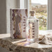 Raasay Gin bottle and box on a stone surface with a scenic background