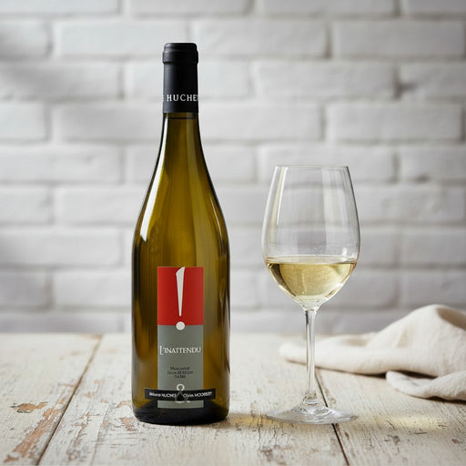 Bottle of white wine with glass.