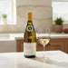 Bottle of Louis Latour Corton Charlemagne Grand Cru with a glass on a kitchen counter