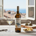 Bottle of Montecalvo with bread and white wine.