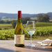 Penfolds wine bottle and glass with vineyard background