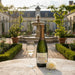 Pierre Moncuit Cuvee Millesime Blanc de Blancs 2014 Champagne with a glass and flower in courtyard.