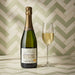 Pierre Moncuit Cuvee Millesime Blanc de Blancs 2014 Champagne 75cl with a glass of champagne on and green and white background.
