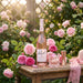 Rozel Rose Vodka in a garden with pink roses and a cocktail
