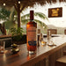 Bottle of Santa Teresa 1790 rum on a bar counter with a tropical setting