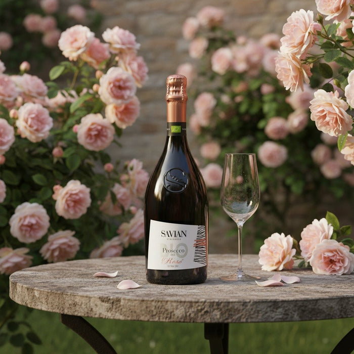 Bottle of Savian wine with a glass on a table surrounded by pink flowers