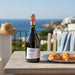 Bottle of Savian Prosecco on a table with a scenic background