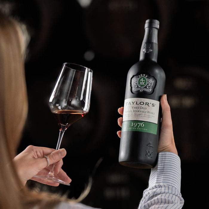 Lady Admiring A Bottle Of Taylor's Very Old Single Harvest Port With Poured Glass In Hand