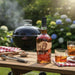 Buffalo Trace whiskey bottle with a glass of whiskey on a wooden table outdoors.