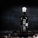 Bottle of Cáfe Solo liqueur on a dark background with ice cubes.