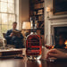 Woodford Reserve Masters Collection Series No.20 Madeira Cask Finish Bourbon bottle with a glass of whiskey in a cosy room