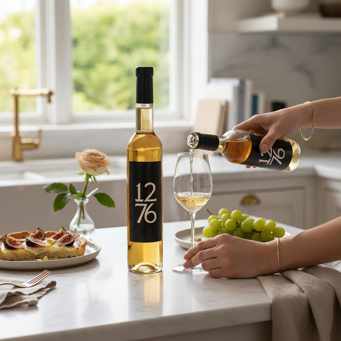 Person pouring wine from a bottle of Evolution 1276 Apple Ice Wine