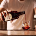  Heering Cherry Liqueur Being Poured Into A Glass Tumbler With Ice