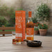 Glenmorangie whisky bottle, glass, and packaging on a wooden table outdoors.