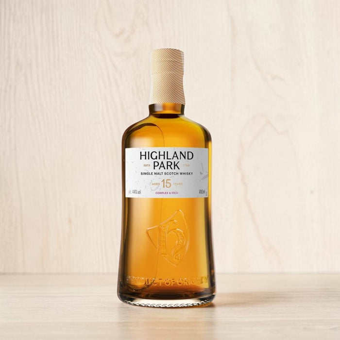 Highland Park whisky bottle on a wooden surface with a light wood background