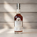Bottle of Leiper's Fork Distillery whiskey on a wooden surface with a blurred wooden background