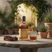 Monkey Shoulder whiskey bottle with a glass of whiskey on a table outdoors.