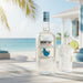 Mount Gay Silver rum bottle with a glass of limeade on a beach setting