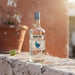 Mount Gay Silver rum bottle on a stone surface with a blurred background