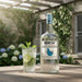 Mount Gay Silver rum bottle with a cocktail on a wooden table outdoors.