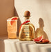 Patron tequila bottle with a cocktail and grapefruit slices on a textured surface