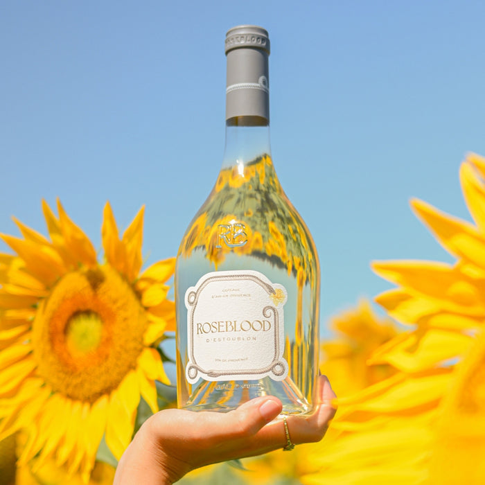 Bottle of Roseblood against a background of sunflowers