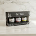 Pack of Sly Gin bottles in a box on a marble surface