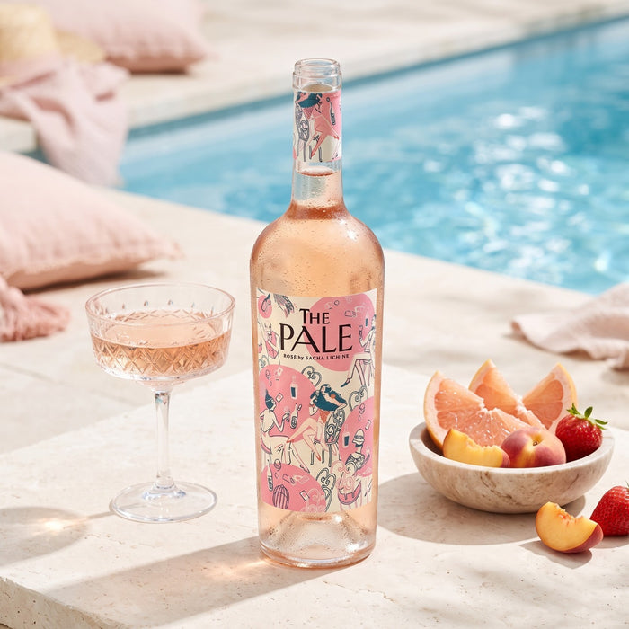 Chateau d'Esclans The Pale Rose with a bowl of fruit, glass of wine near the pool