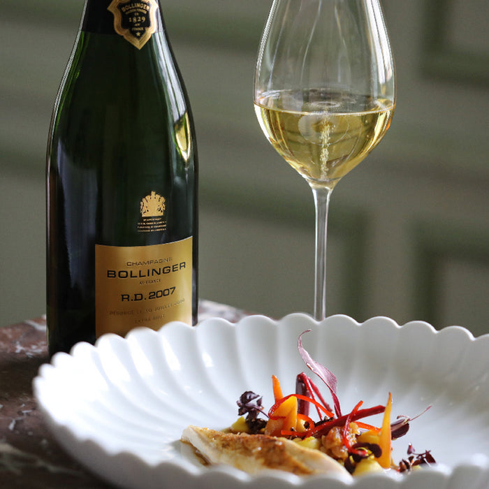 Bollinger R.D. 2007 Vintage Champagne Next To Glass And Food
