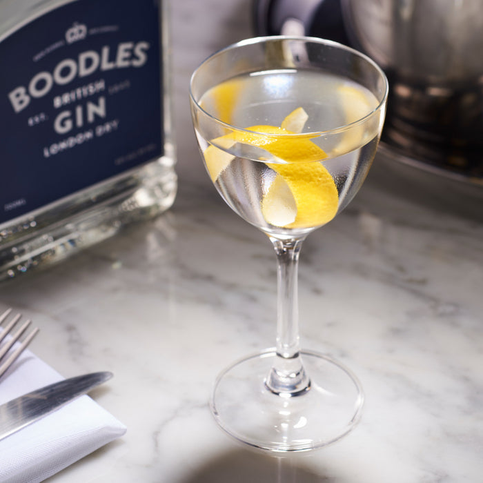 Boodles Gin And Glass Of Gin And Tonic With Lemon Twist