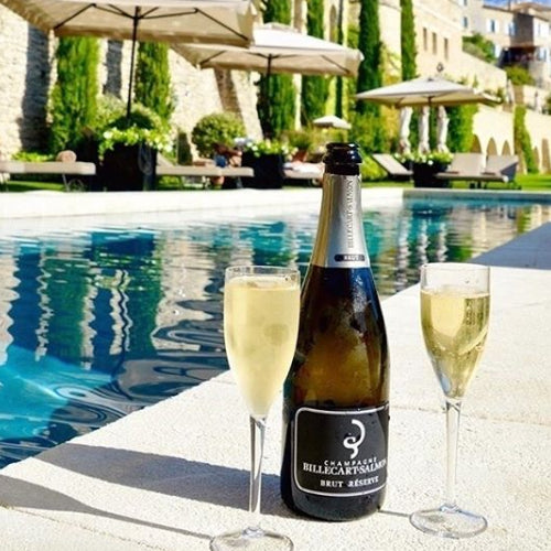 Billecart-Salmon Brut Reserve NV Champagne in flutes by a swimming pool