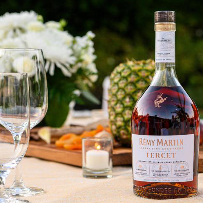 Remy Martin Tercet Cognac 70cl And Two Glasses With Blurred Landscape 