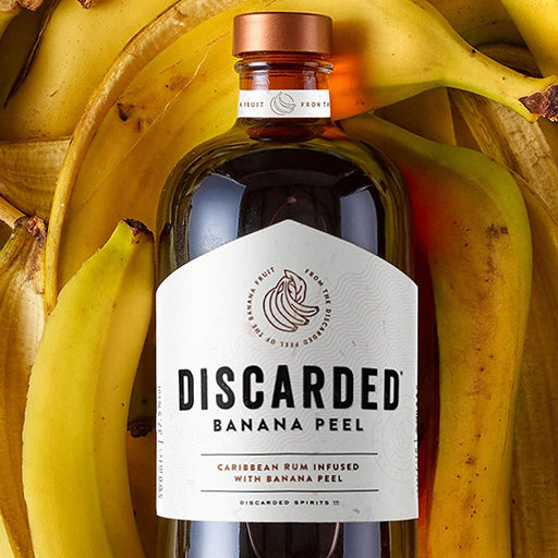 Discarded Banana Rum 70cl With Background of Banana Peels
